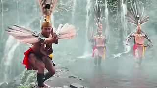 DAYAK MAN DANCING IN THE JUNGLE