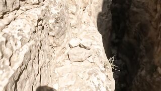 Rockfall Traps Explorer on a Narrow Canyon Ledge
