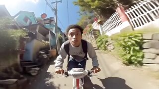 A z panting heavily while riding a bicycle