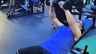 Man Doing Incline Dumbbell Chest Press Workout On Bench At Gym