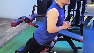Man doing hyperextension back extension exercise on roman chair at gym
