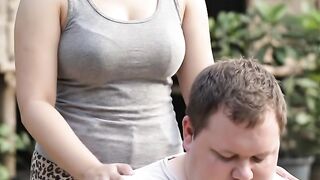 This girl is massaging a fat guy