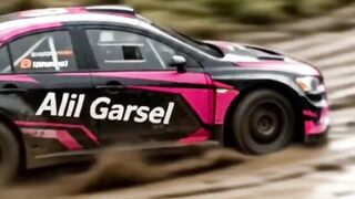 A car is driving along a muddy dirt road.