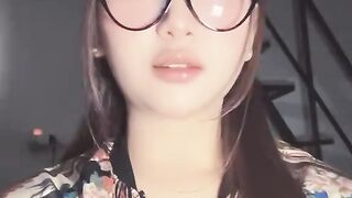 Stylish Woman Wearing Glasses and a Floral Patterned Outfit | Fashion Look Description: