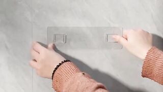 Adhesive toothbrush holder and toothpaste squeezer