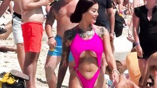 A sexy woman on the beach arouses two men