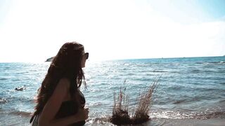 Female Tourist Enjoying Beach Walk During Summer Holiday