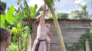 Mama picking papaya for her children