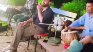 Local singer sing a song at night in park