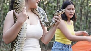 Beautiful woman camping in the forest, caught a poisonous snake