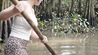 Beautiful woman is fighting against a big swamp crocodile