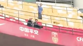 A Chinese supporter waves a Palestinian flag during a friendly football match between Palestine and China in Chongqing, China.
