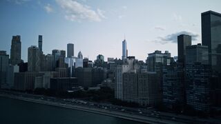 Aerial view of Chicago skyline by the waterfront at dusk.