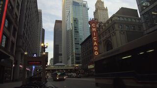 Dynamic shot of Chicago's skyline with the famous theater marquee.