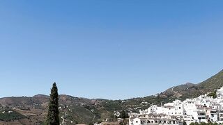 Explore a tranquil Andalusian village with scenic mountain vistas and whitewashed architecture.
