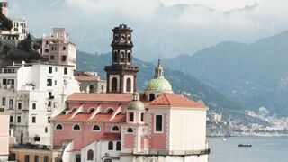 Stunning view of Amalfi Coast architecture with blue sea and mountains.