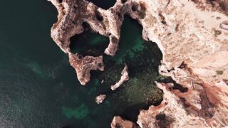 Explore the breathtaking cliffs and turquoise waters of Algarve, Portugal.