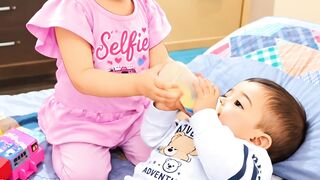 Baby feeding baby