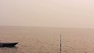 Golden Sunset Over Calm Seawater with Small Fishing Boats