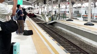 Indonesian Commuter Train Arriving at Railway Station Platform