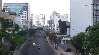 Aerial Drone View Flying Over Busy City Avenue With Modern Office Buildings And Traffic In Surabaya