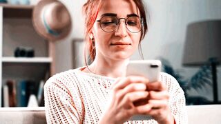 Attractive Woman Using Mobile Phone at Home