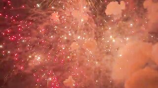 Golden Fireworks Exploding in the Night Sky with Glowing Sparks and Smoke