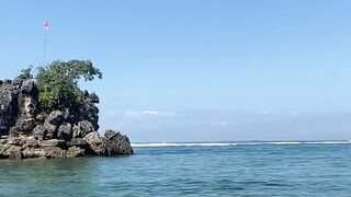 Beautiful Ocean Waves Hitting Rocky Shore on a Sunny Day