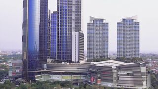 Aerial View of Modern Blue Glass Skyscrapers, Office Towers, and Shopping Centers in Surabaya