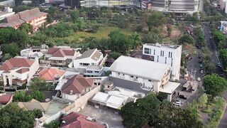Aerial View of Ciputra World Surabaya with Blue Glass Tower and Residential Area