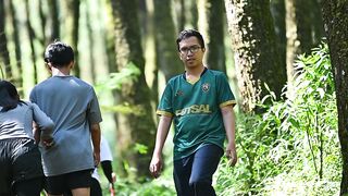 A man is trail running in the forest.