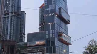 Urban street at dusk with traffic and tall buildings