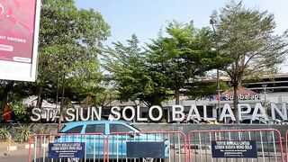 Red bus parked near signboard under clear sky