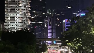 Night city lights shine bright above busy traffic