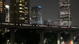 Night skyline glows above dark river water