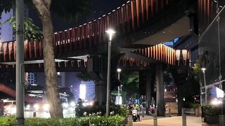 Urban night scene with illuminated pedestrian bridge