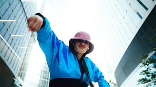 Stylish Woman Flirting With Camera During Sunny Urban Walk