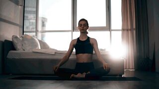 Woman Finding Inner Peace Through Yoga Meditation at Home 2