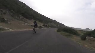 Angry ostrich chasing cyclists