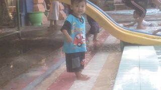 a small child playing by the edge of a swimming pool