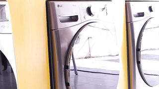 Row Of Modern Front Load Washing Machines And Dryers Mounted On Yellow Wall In Laundromat Interior Clean Laundry Shop