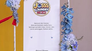 Congratulation Flower Board for the 24 Hour Joss Laundry Grand Opening Celebration, with Blue and Yellow Artificial Flowers in Indonesia