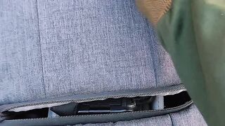 Hand Opening Gray Backpack Zipper Close Up Outdoor On Red Running Track Travel Bag Product