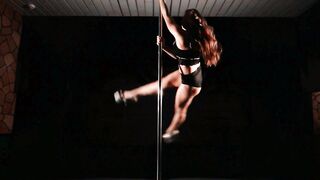 Female Pole Dancer Executing Complex Aerial Tricks