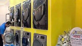 Modern Self Service Laundromat Interior Yellow Wall Stacked Washing Machines Employee Working Coin Laundry Business