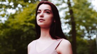 Woman Admiring the Natural Landscape in a Tranquil Forest