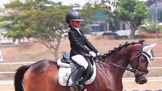 Young Equestrian Girl Trotting Brown Horse Side View In Sandy Arena Dressage Training Formal Uniform