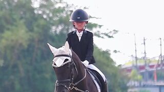 Young Girl Dressage Rider On Black Horse In Official Dressage Arena With Letter Markers Competition Training
