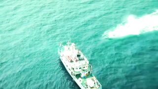 Below Calvin, Dr. Syed, the Submarine, and the giant sea Creature