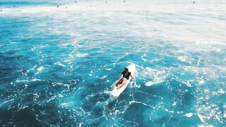 Surfer Riding Ocean Waves on a Beautiful Sunny Day